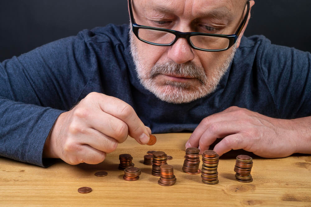 man counting pennies
