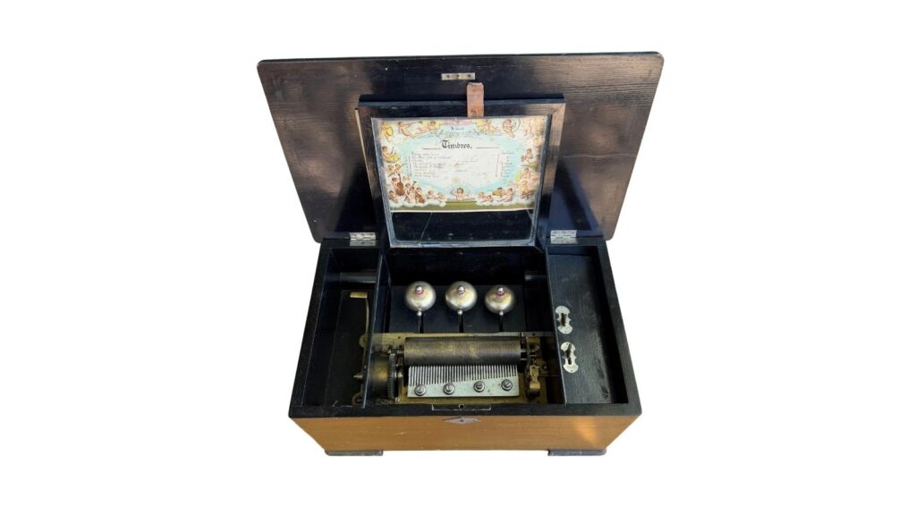 Antique Swiss cylinder music box with bells in sight