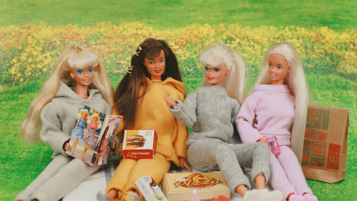 Barbies sitting on grass