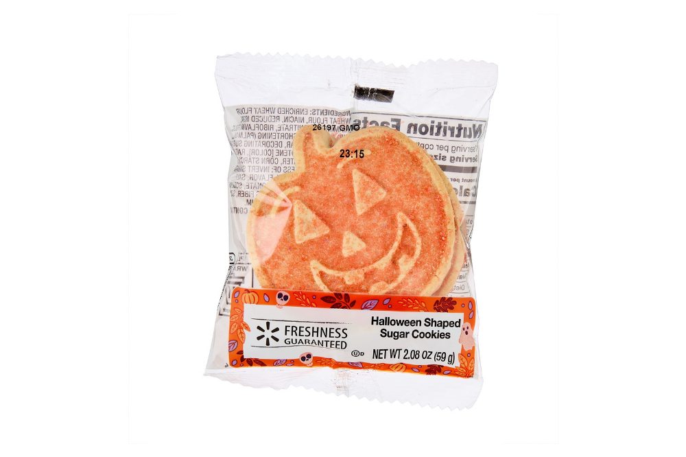 Package of two orange pumpkin-shaped sugar cookies with smiling jack-o’-lantern faces