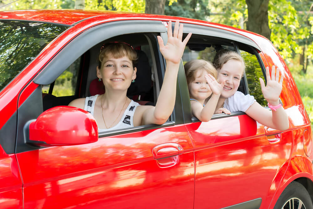 A single mom and her kids enjoy their free car.