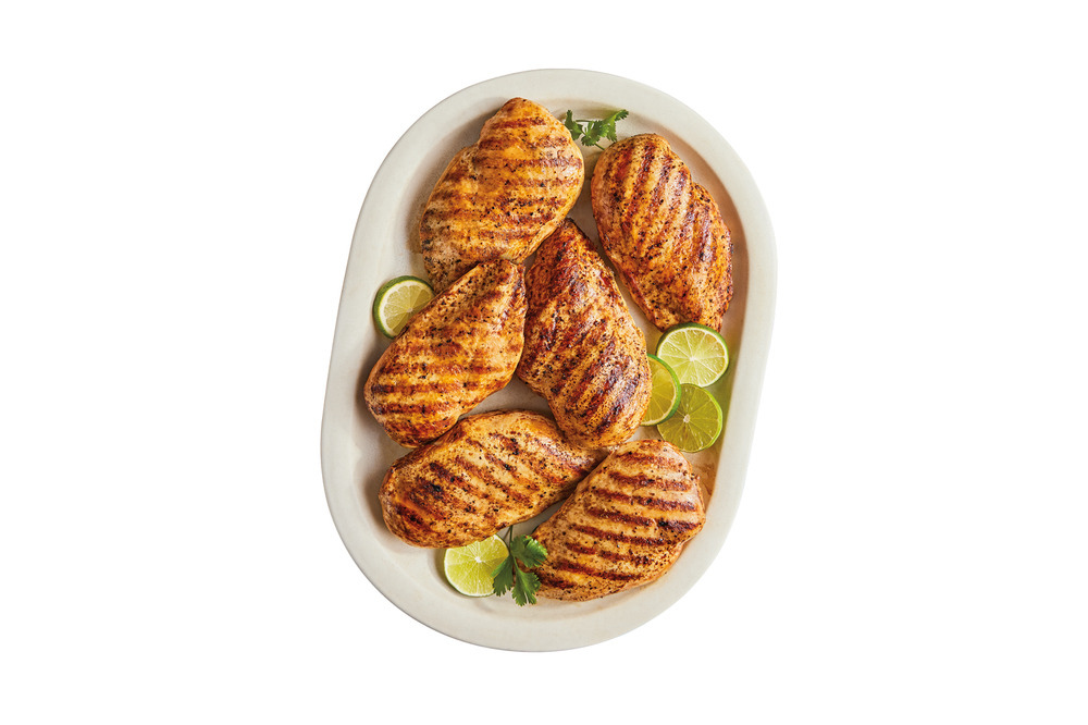 Cooked chicken breasts with grill marks on a platter