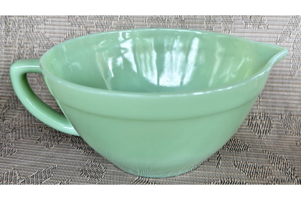 Fire-King jadeite batter bowl with a pouring spout and side handle
