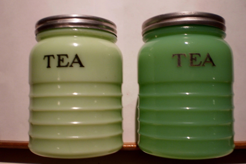 Two Jeannette jadeite tea canisters with metal lids