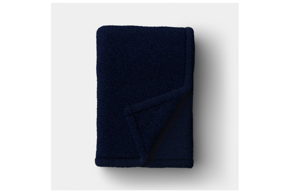 Folded navy Room Essentials plush throw blanket