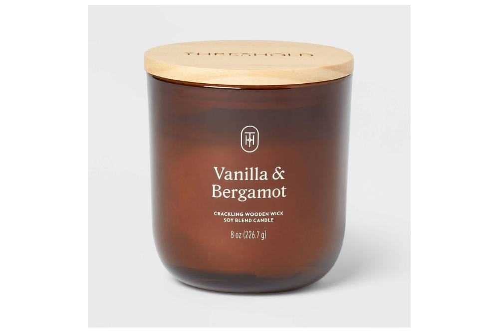 Threshold vanilla and bergamot candle in an amber glass jar with a wooden lid