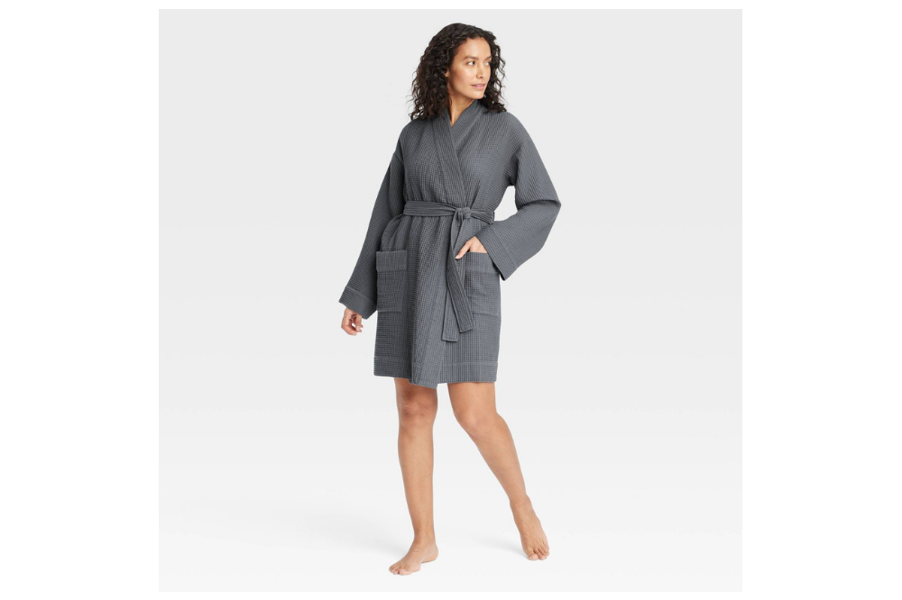 Woman wearing a dark gray Auden waffle robe