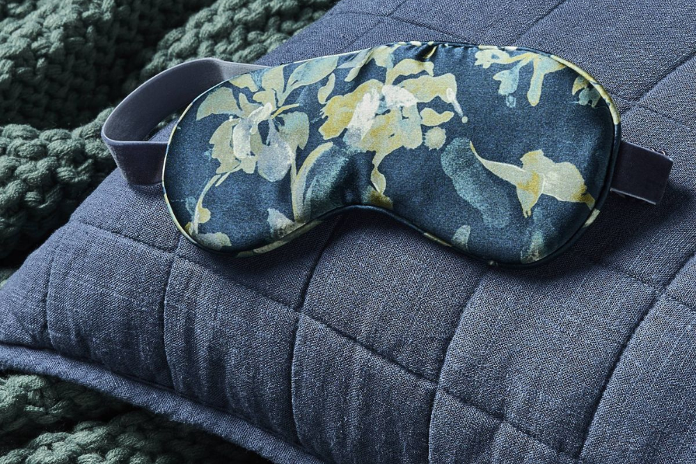Casaluna floral silk eye mask on blue bedding