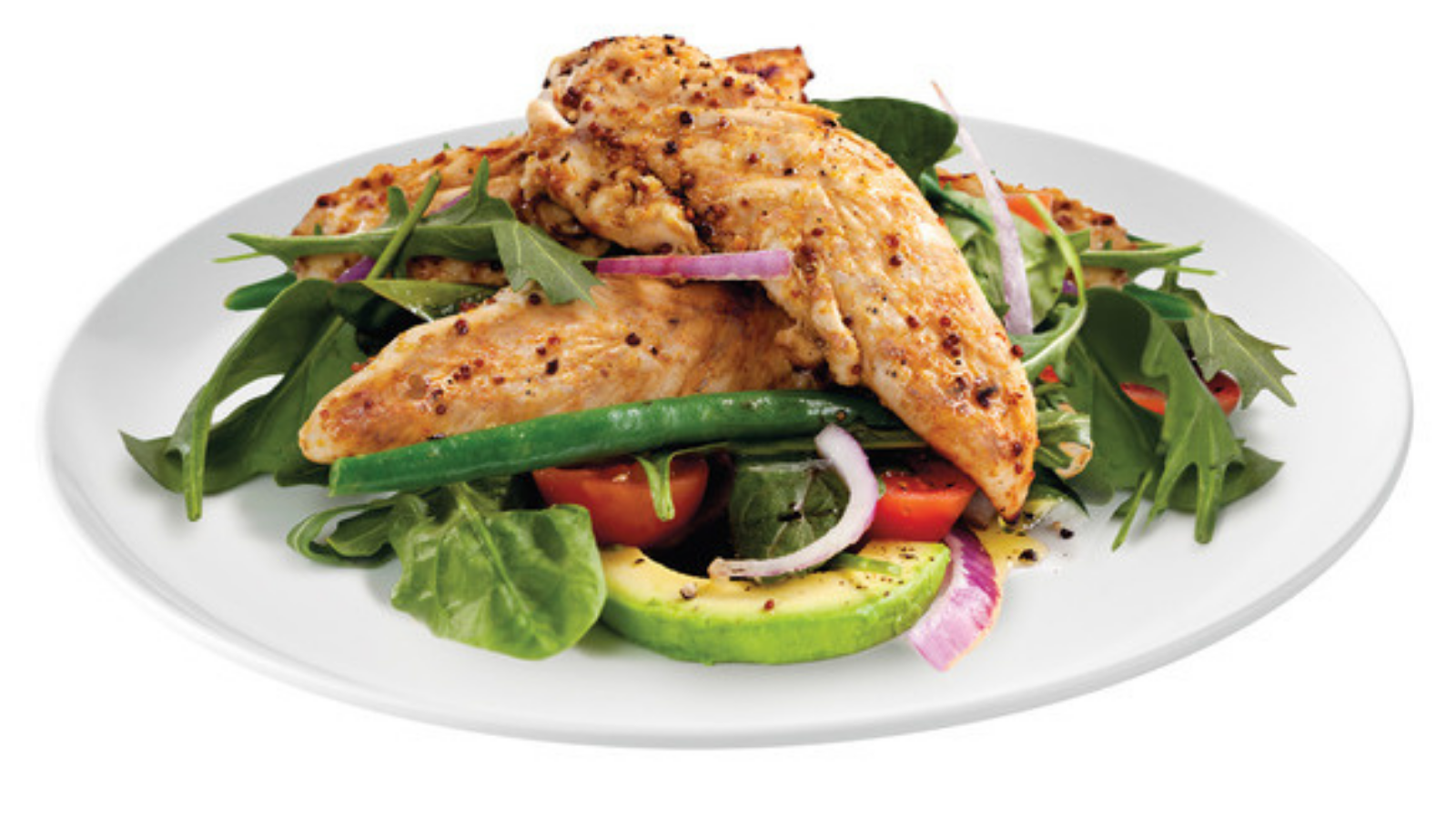 Cooked chicken tenderloins served over salad on a white plate