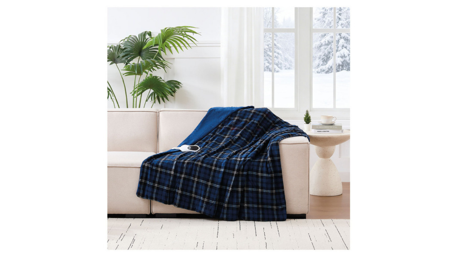 Blue plaid Biddeford heated throw draped over a chair