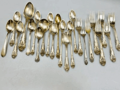 Silver flatware including spoons and forks for sale as part of an estate.