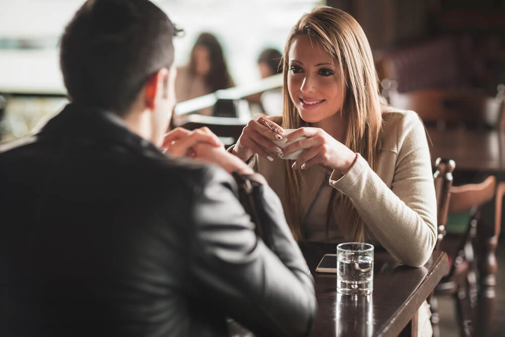 The woman smiles at the man she's meeting. Meet the love of your life through eharmony.