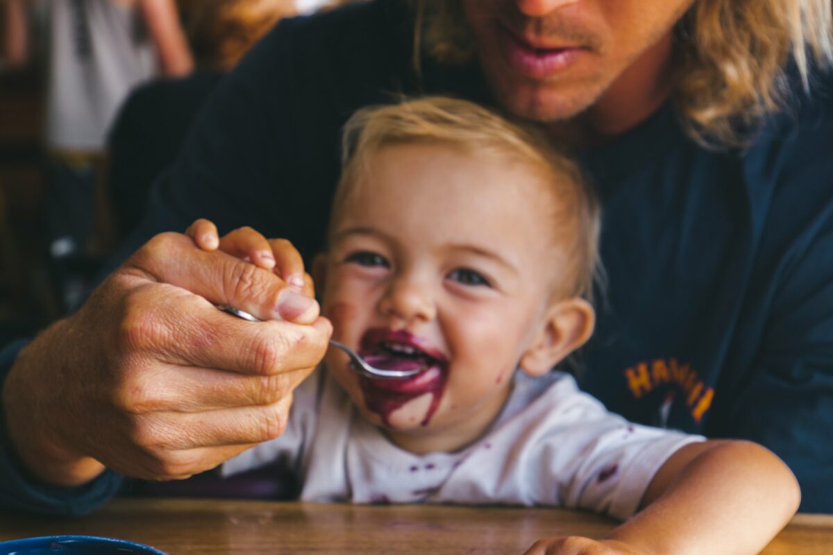 child eating chocolate cake