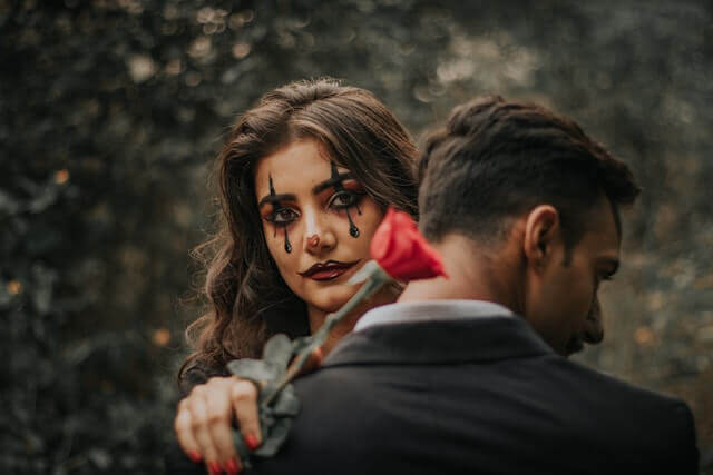 girl in romance with clown paint on