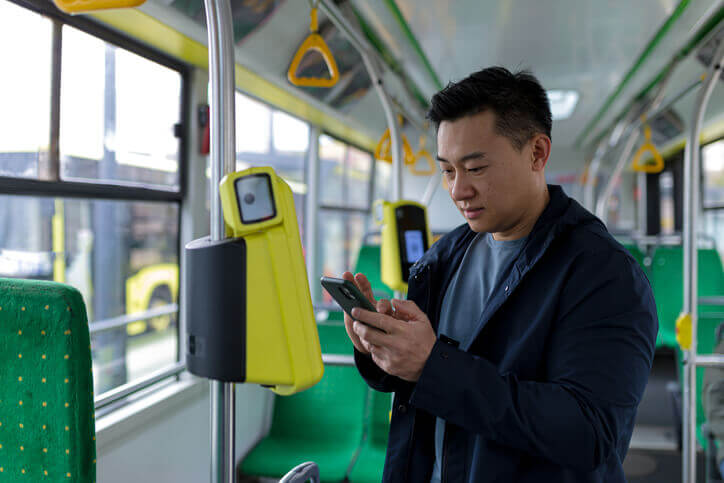 Man rides a bus with a free bus pass.