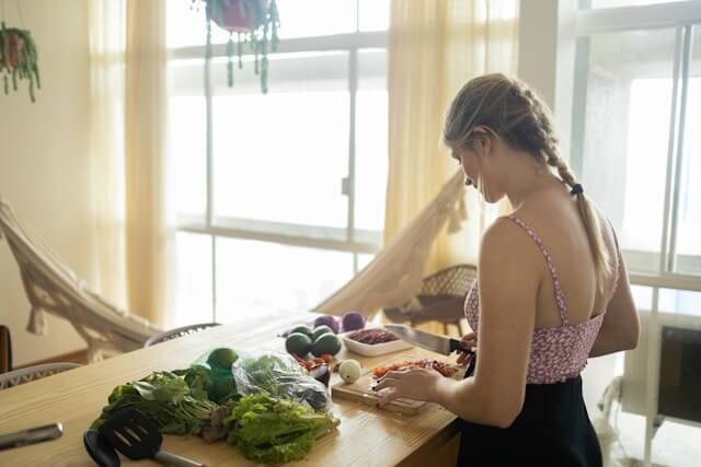 person chopping vegetables