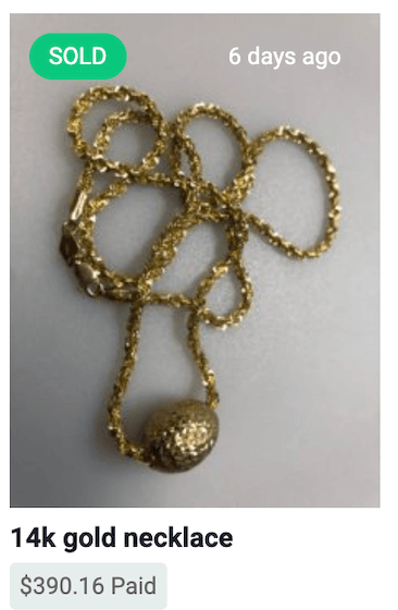 Gold chain necklace with pendant.