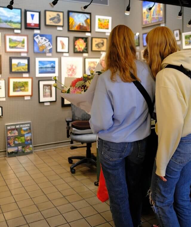 looking at paintings in store