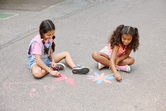 children busy playing with chalks