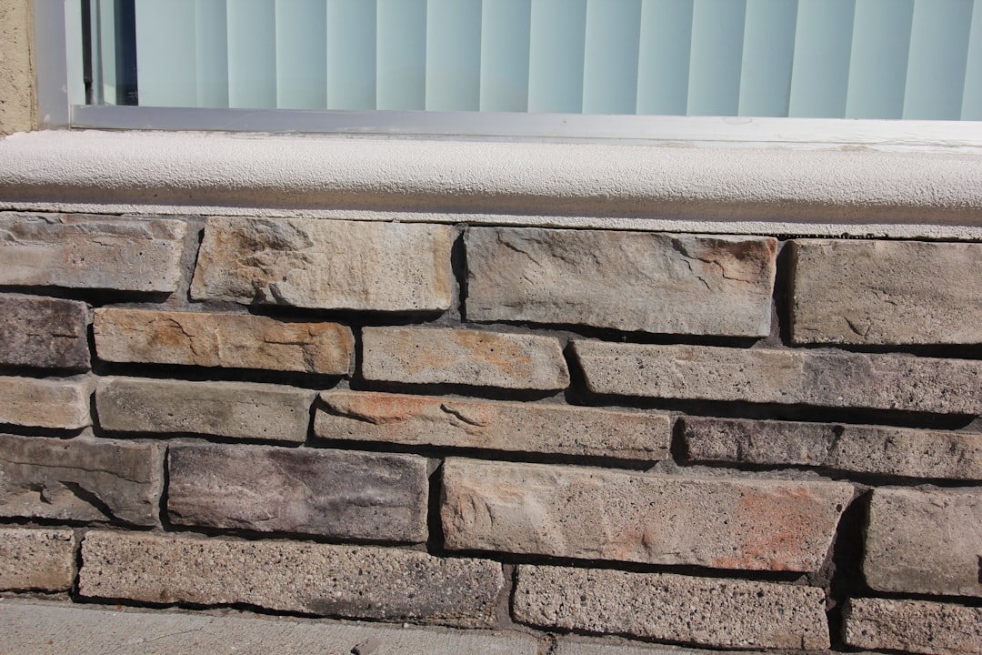 a close up of a brick wall with a window