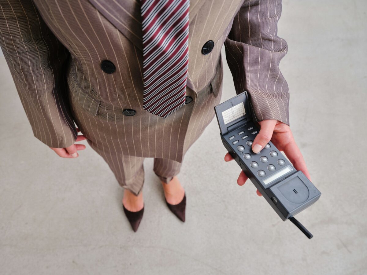businesswoman using old cell phone