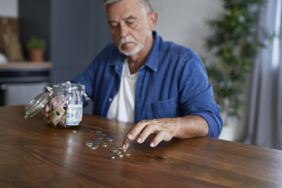 Senior man leaning at the table with financial problems