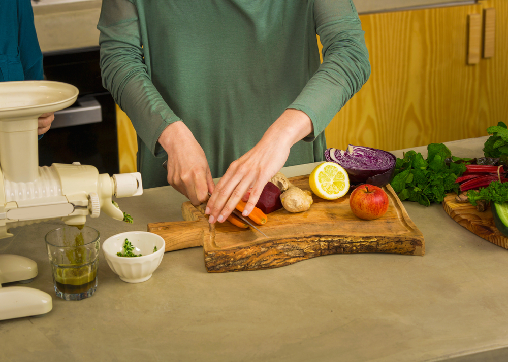woman using a centrifugal juicer