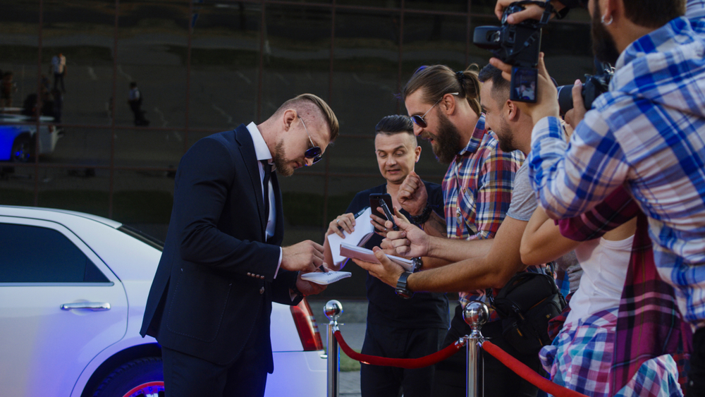 actor giving autographs