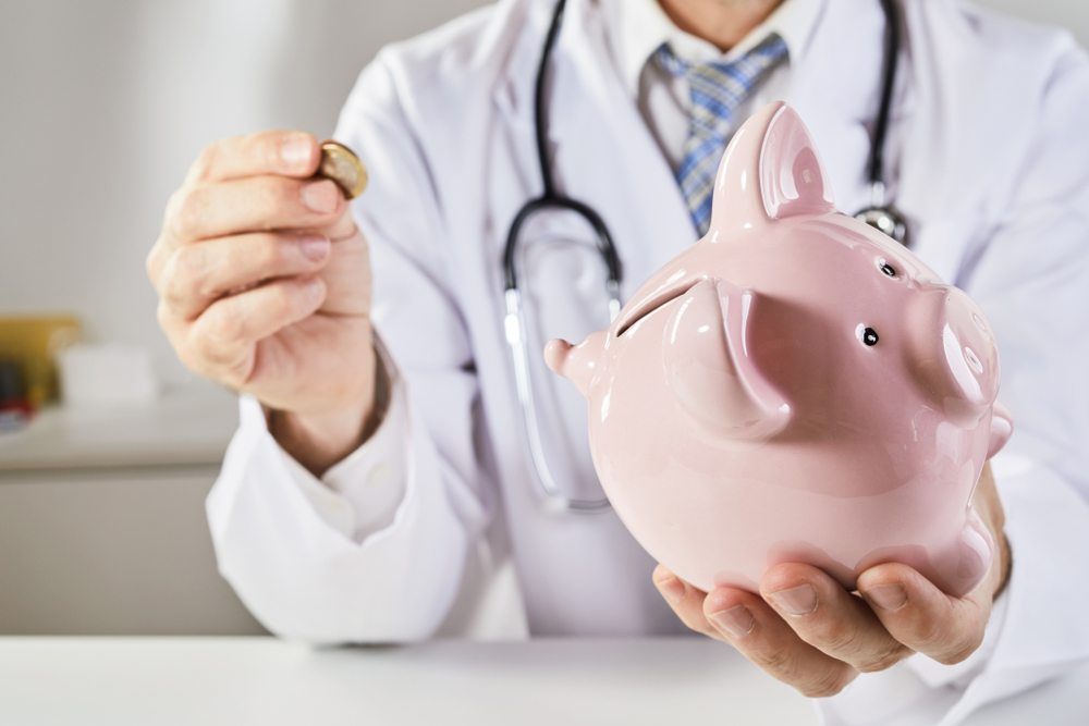 doctor putting money in piggy bank