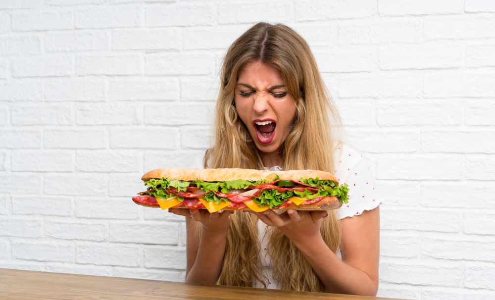 person eating a baguette