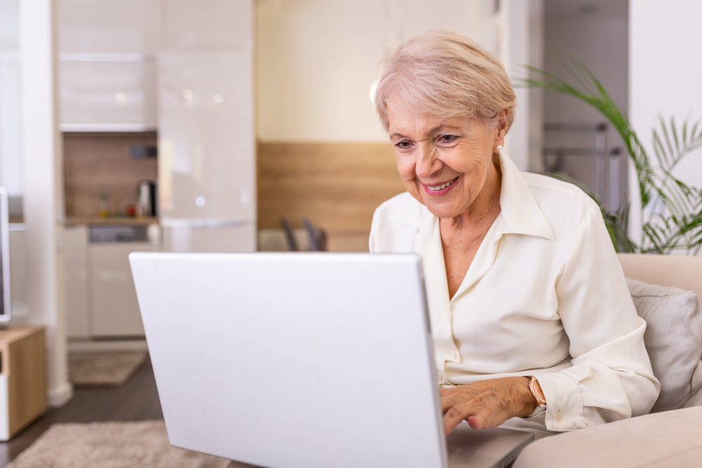 older personn looking for job on laptop