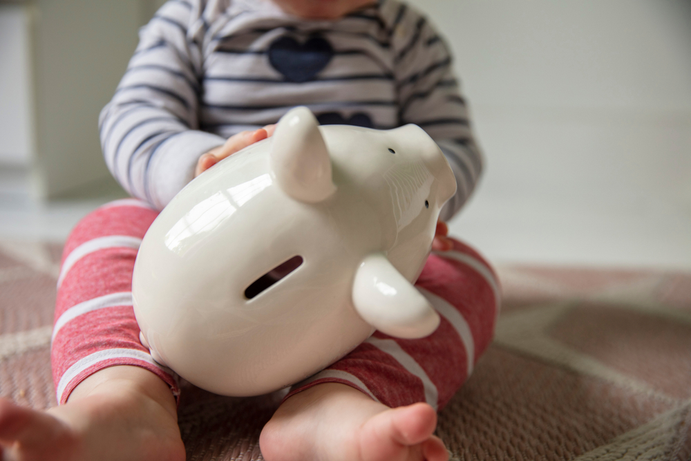 child and piggy bank