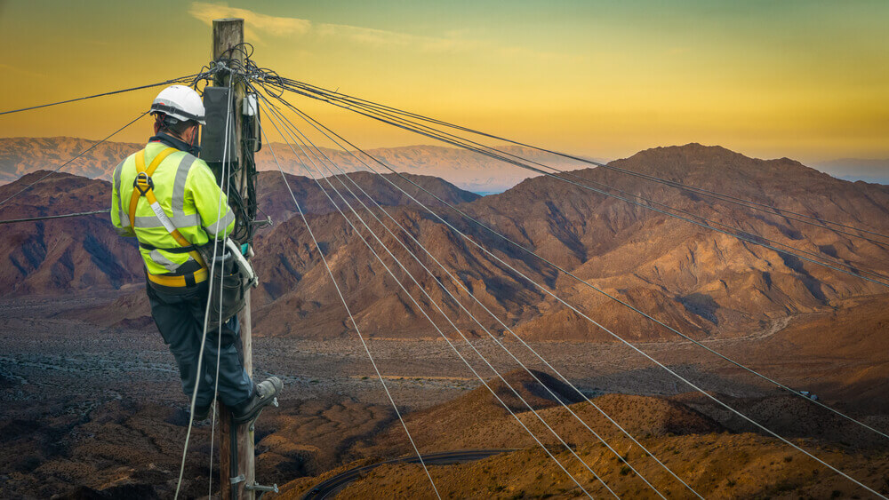 Lineworker Or Engineer In A Remote Desert Landscape