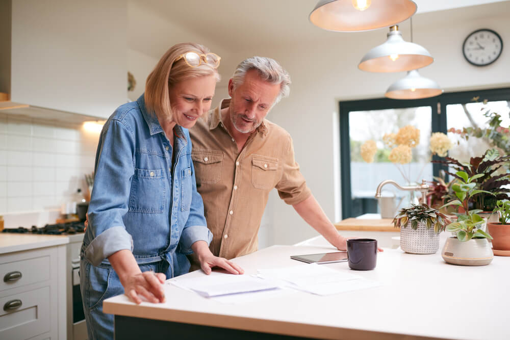 Middle-aged couple reviewing finances together at home