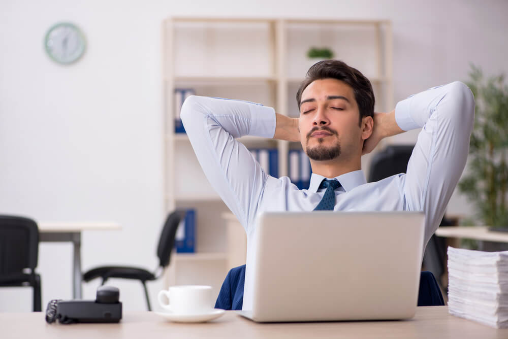 Laptop open with person leaning back, disengaged