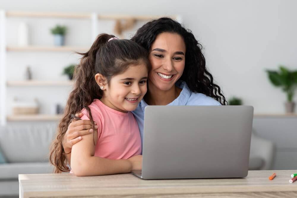 happy child and mom on laptop