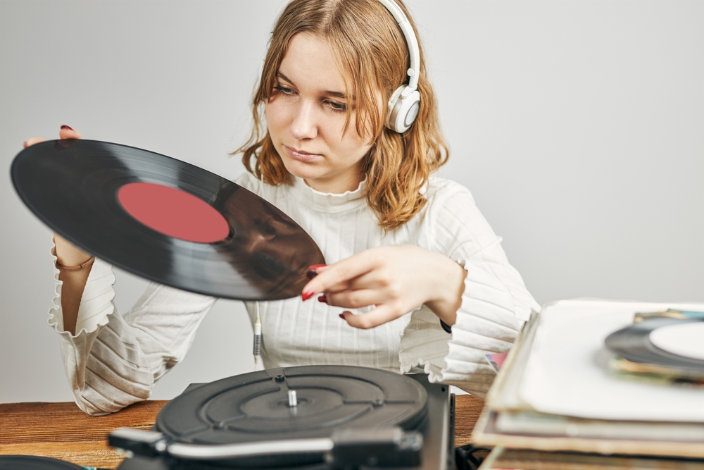 woman listening to vinyl records
