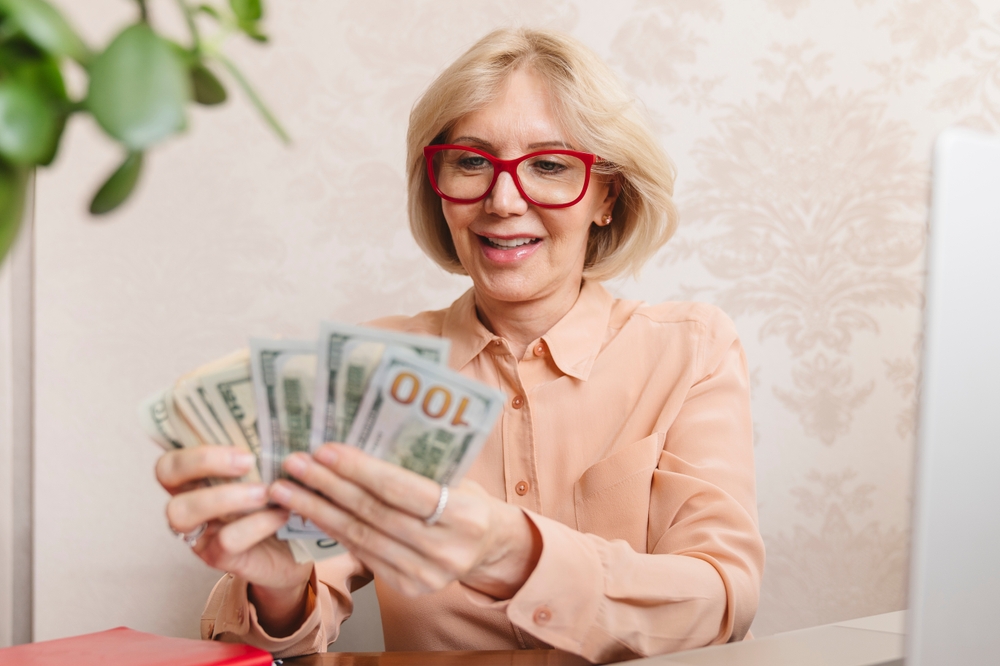 older woman happy with money