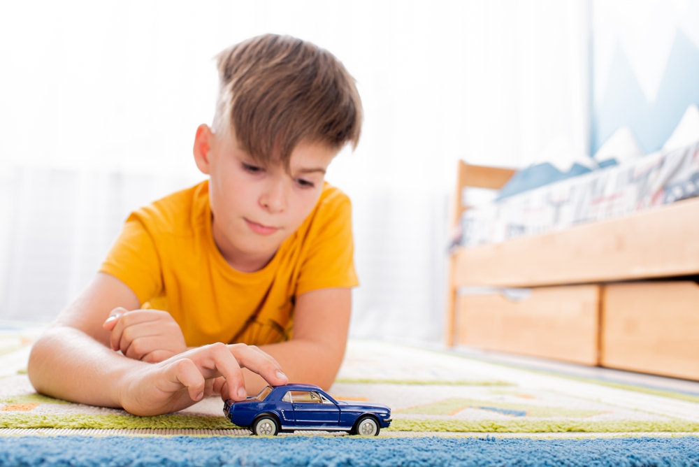 boy playing with cars