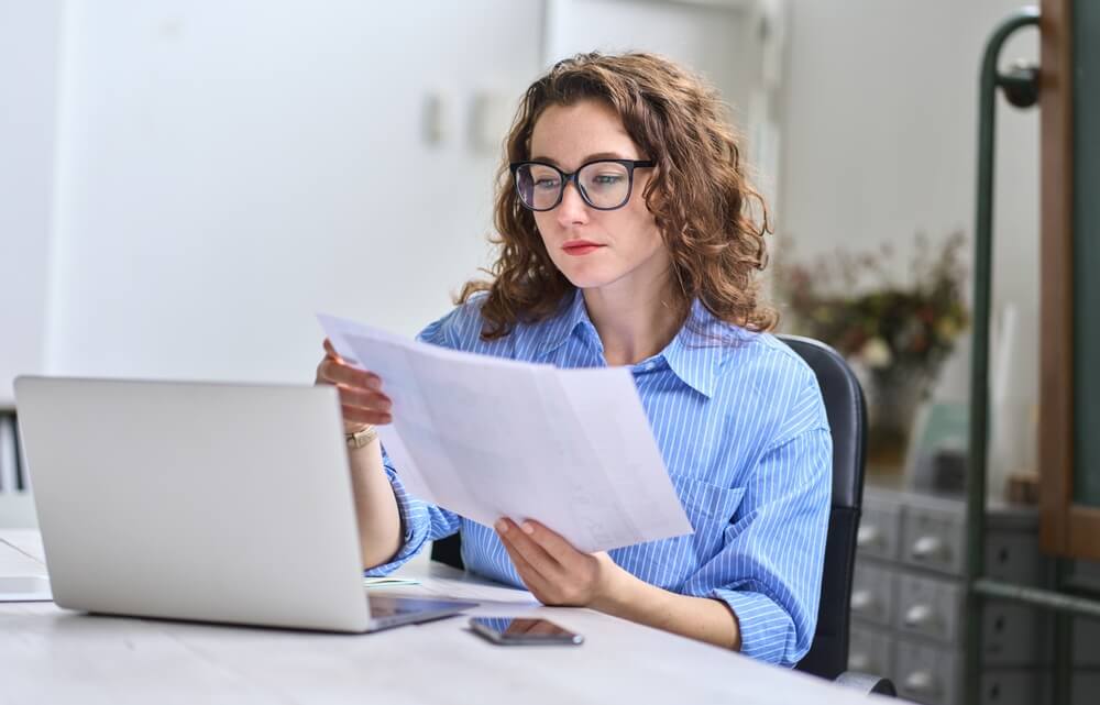 Person reviewing insurance paperwork at desk