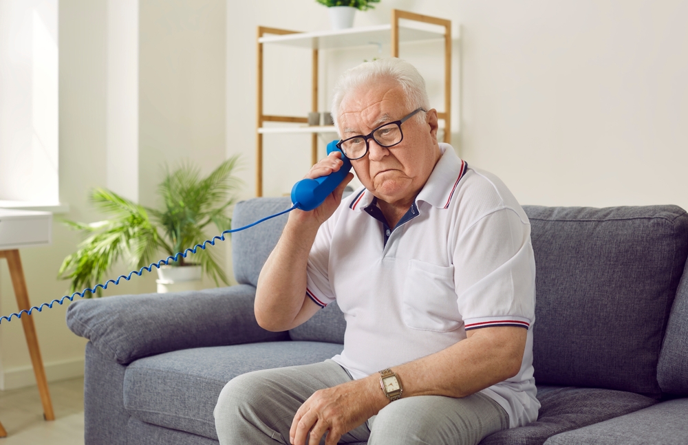 senior man holding phone wrong way round