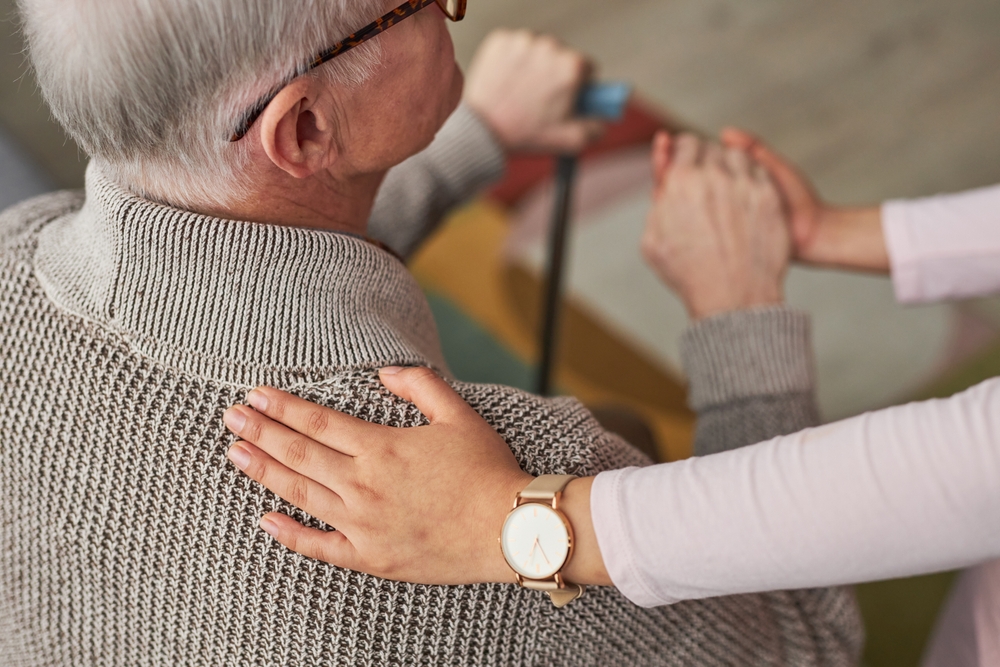 sister puts reassuring arm on older brothers shoulder