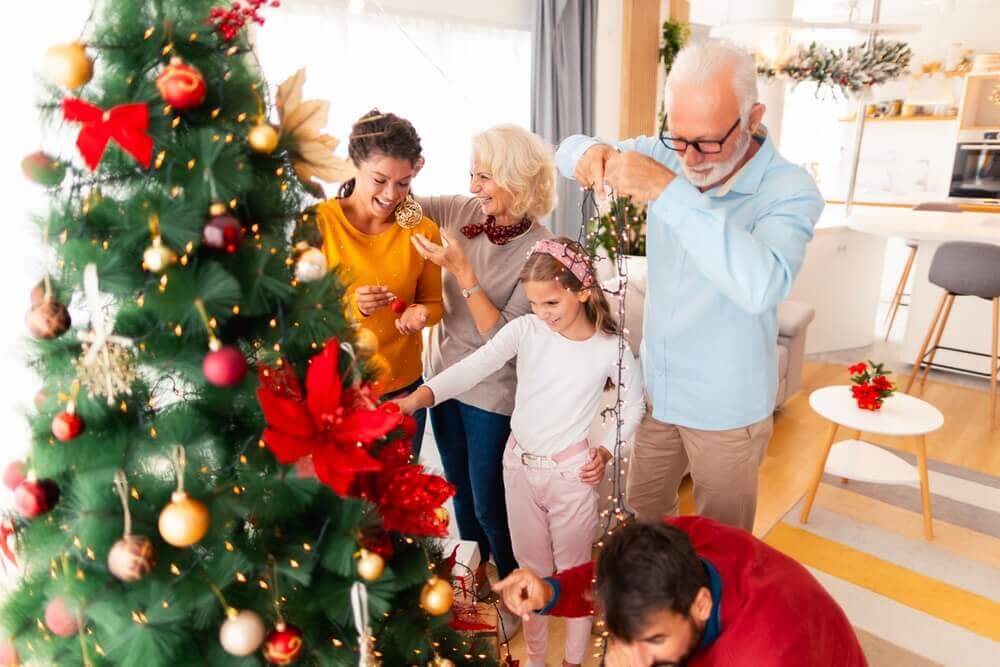 family decorating a Christmas Tree