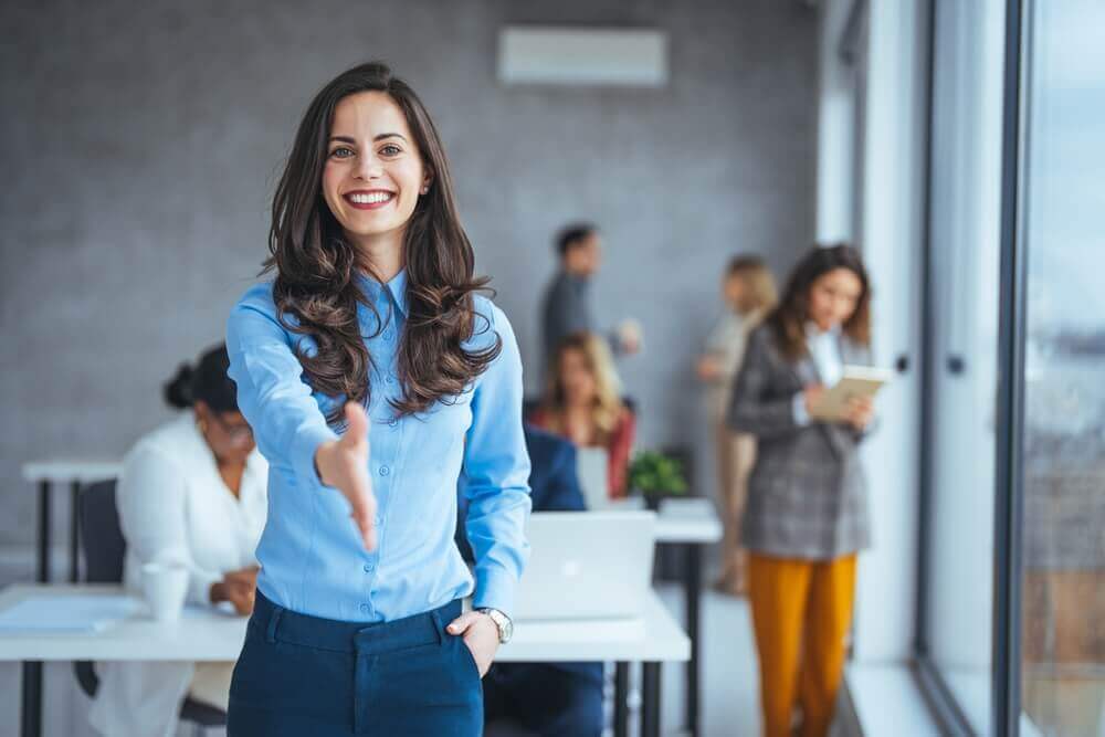 woman shaking hands with potential employee
