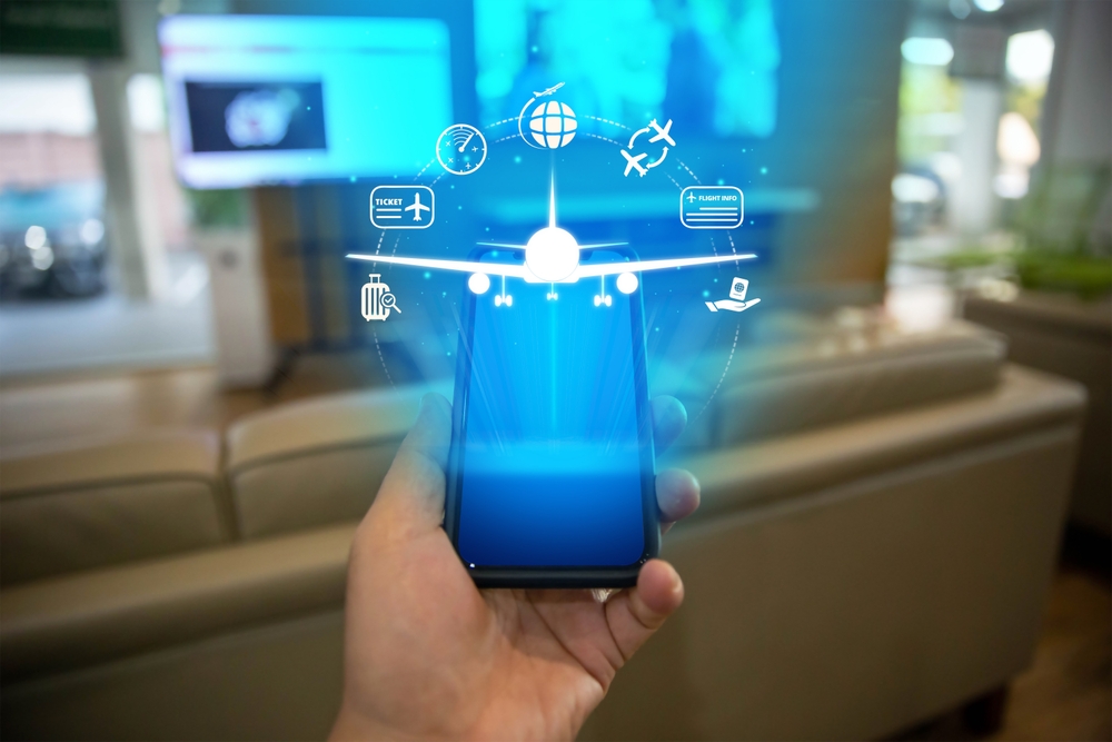 Hand holding a smartphone with flight booking and travel icons