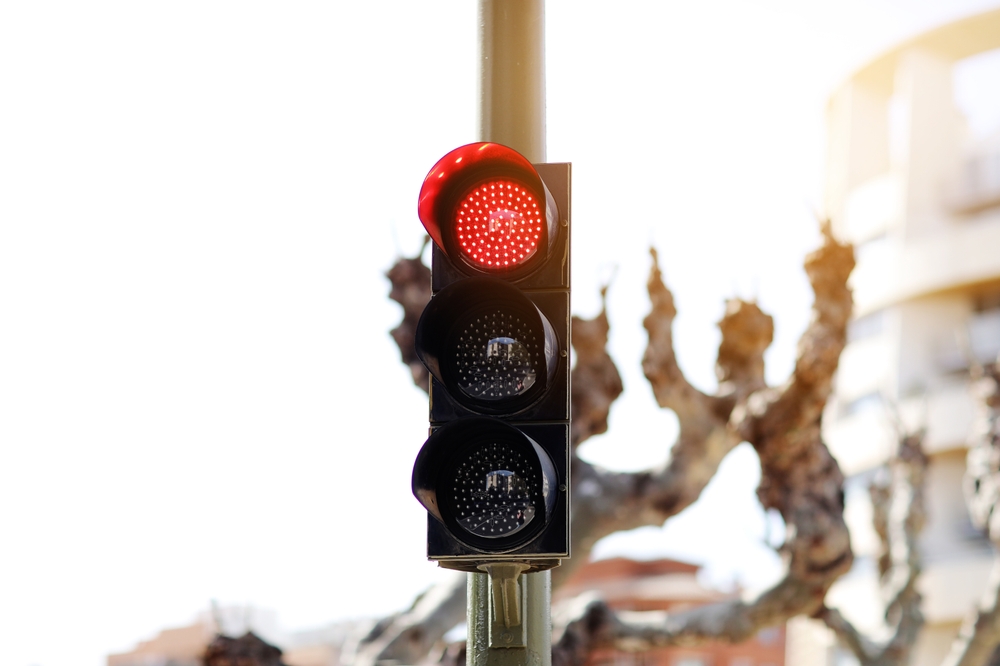 Red LED traffic light mounted above a city street