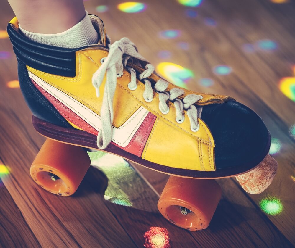 Retro roller skates on wooden floor