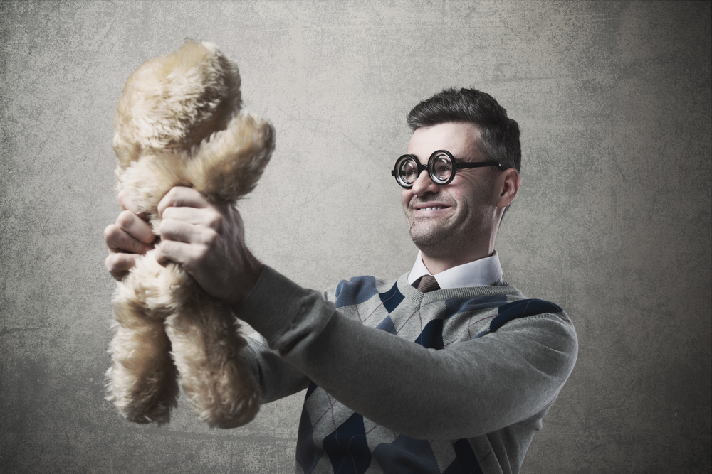 man with glasses and plush