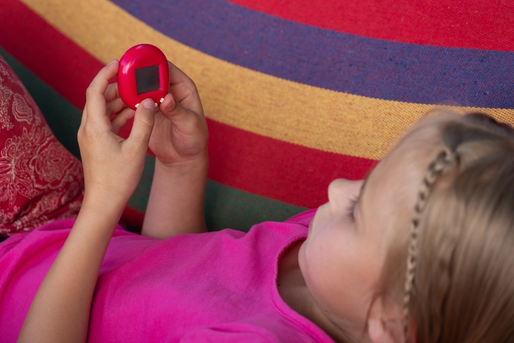 girl playing with tamagotchi