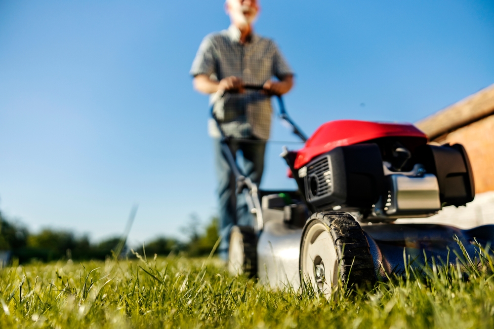 older person mowing lawn